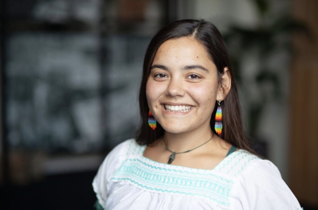 image of woman in white shirt and colorful earings